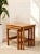 A handsome set of three vintage nesting tables featuring warm teak tones and a clean, space-saving design. Each table is...