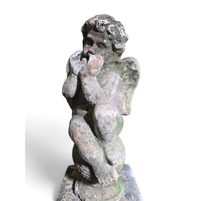 An exceptional and highly decorative pair of 19th-century Italian terracotta cherub sculptures, each accompanied by its...