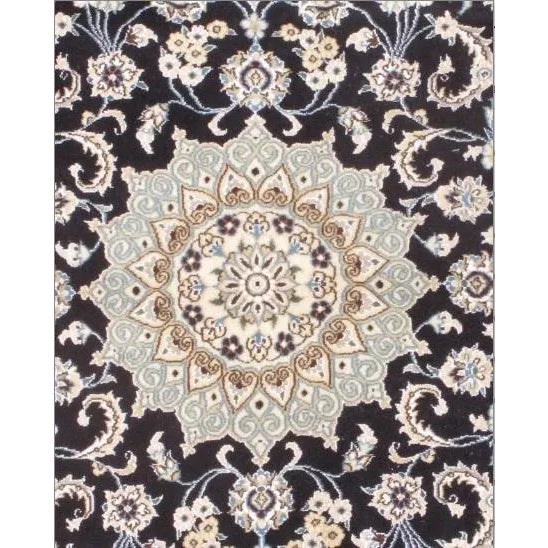 Persian Nain rugs are renowned for their detail and fine use of outlining along the central motifs. Breaking from the...