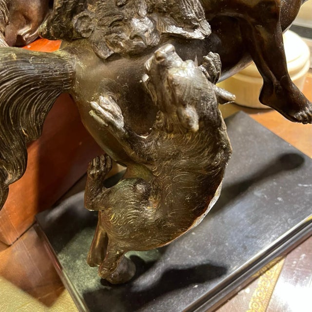 Large bronze figure of an American indian on horseback wielding an axe, defending himself from an attacking mountain lion...