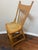 Charming antique American oak youth dining chair dating to circa 1900, featuring an ornate floral pressed-back crest,...