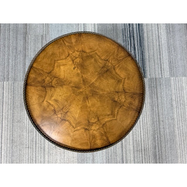 This is a vintage Baker Furniture French Louis XVI Style Accent Table featuring a book-matched walnut veneer top and a...