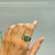 The Contemporary Wide-Band Octagon-Cut Green Emerald Statement Signet Ring features a striking 2.74 carat emerald in a...