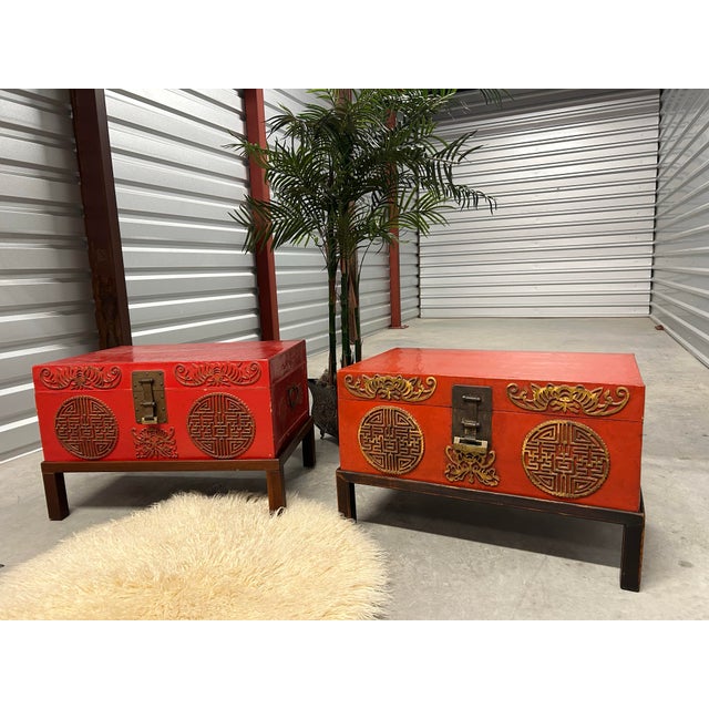 Two beautiful red dyed and lacquered pigskin trunks. Incredibly gorgeous detail on front and side. Solid brass handles and...