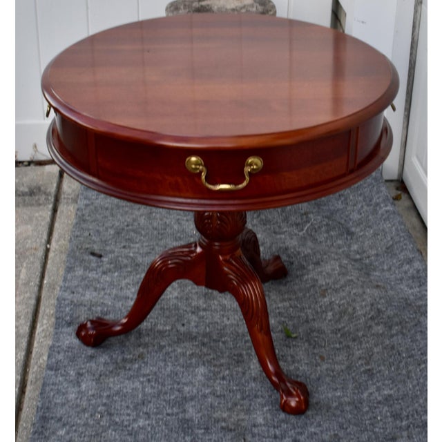 Vintage (1980's) Round Drum Table has a Chippendale Style. Made of Wood. Mahogany. The Table has One Drawer and a Carved...