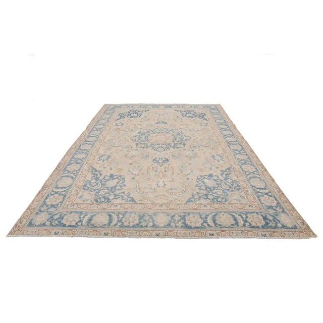 Handknotted vintage washed out large Tabriz rug. Approximately 60-70 years old. In very good condition.