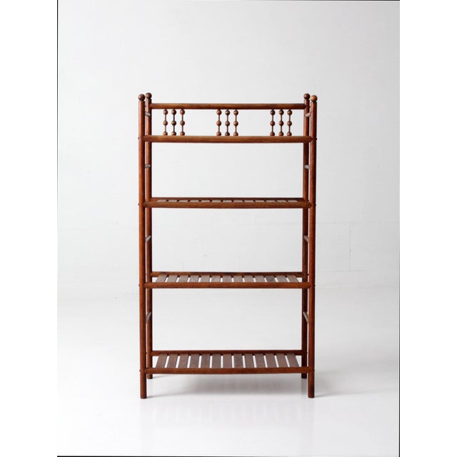 Antique Victorian étagère with turned spindle detailing and finial-capped posts. The vertical, open form feels structured...