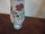 Tall and elegant Chinese porcelain baluster shaped vase decorated with precious objects in famille rose palette. The glaze...