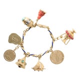 1950s 18k Gold Multi Vintage Charm Bracelet on Enamel Chain For Sale