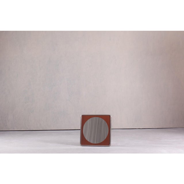 This vintage German wall mirror dates from the 1970s and features a distinctive circle-within-a-square design. The...