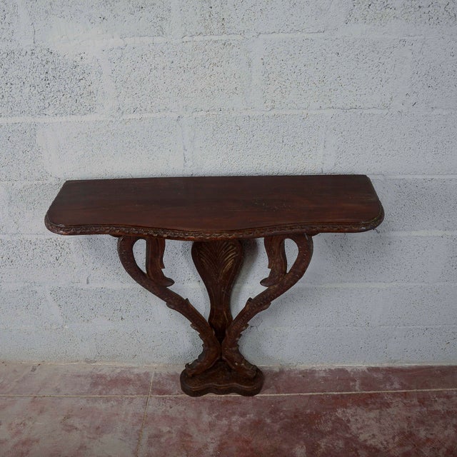A refined vintage carved wood wall console table, an elegant antique piece ideal for entryways or hallways. This piece...