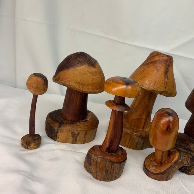Add a touch of whimsical, rustic charm to your space with this enchanting collection of seven hand-carved wooden...