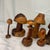 Add a touch of whimsical, rustic charm to your space with this enchanting collection of seven hand-carved wooden...