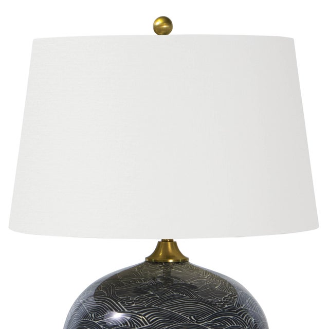 Ride the wave with this Japanese inspired ceramic black-and-white table lamp. Its crisp white shade and antique brass...
