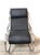 Rocking chair made by Heals, London, 1970s. The chair features a tubular steel frame and black eco-leather, completely...
