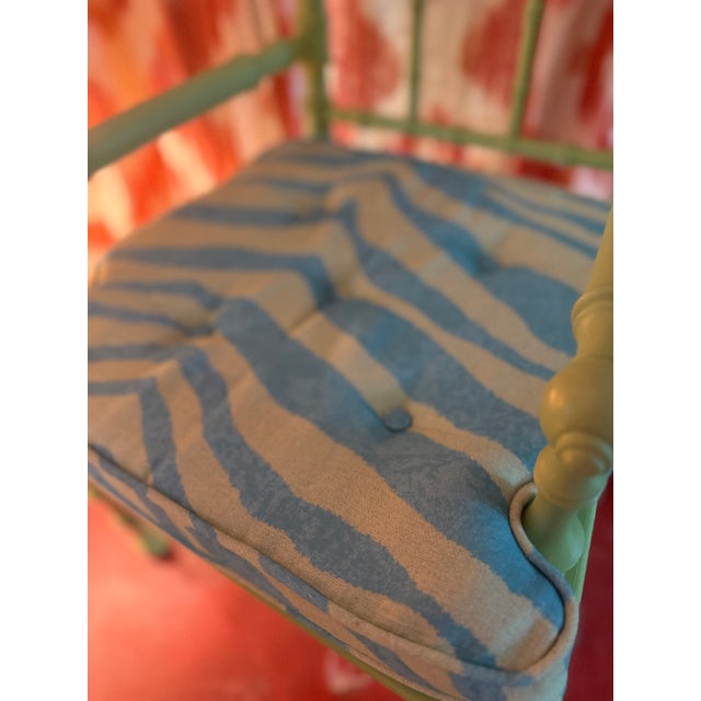 A very lovely child’s chair in the arts and crafts style in faux bamboo. Painted apple green with an contemporary cushion