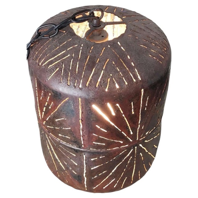Here we have one large pierced metal pendant light. That gives off a starburst design when lit. It appears to be hand...