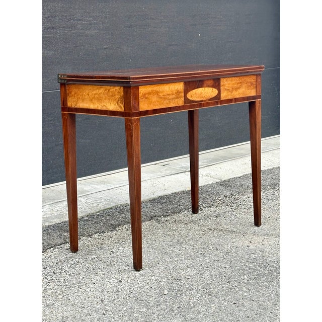 This beautifully made elegant Federal/Hepplewhite game/console table has all characteristics of this period: clean lines,...