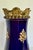 This lovely mid-20th-century European ceramic vase features a rich cobalt blue glazed finish accented with elegant gilt...