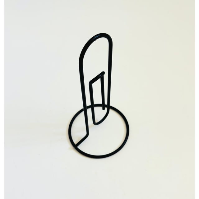 A vintage extra large black metal paperclip for keeping letters, notes, or displaying photos. Measures 3" in diameter x...