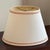 A beautiful and well-preserved oval Empire-style lamp shade from the late 20th century. Soft ivory exterior fabric and a...