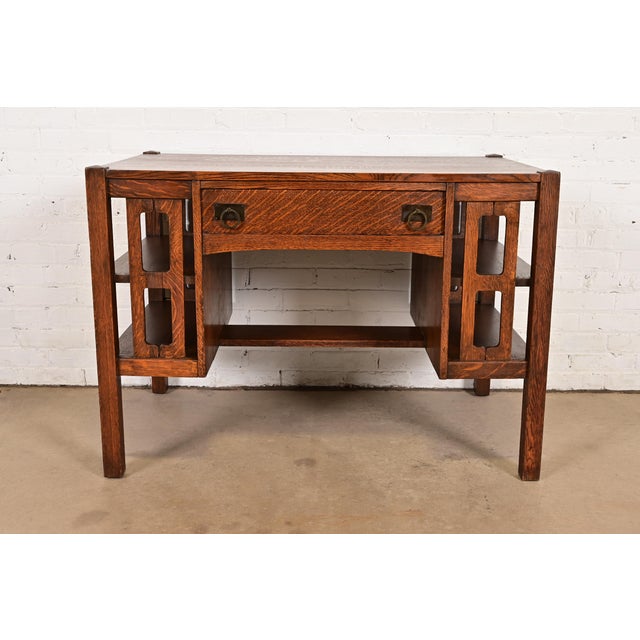 An exceptional antique Mission or Arts & Crafts period writing desk or library table with built-in bookcases In the manner...