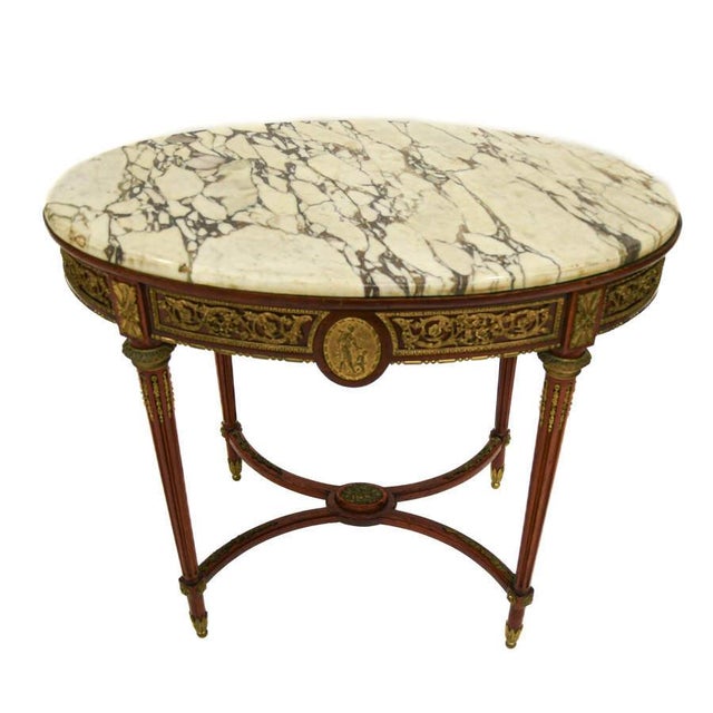 This elegant antique Rococo‑style center table is a commanding decorative statement, distinguished by its richly veined...