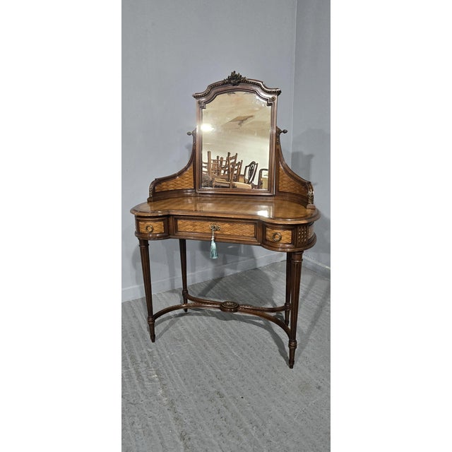 A wonderful French kidney shaped dressing table, with parquetry veneers, U shaped undertier, wonderful mounts and swing...
