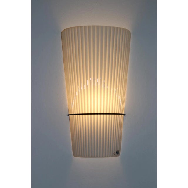 Toso Wall Lamp White Murano Molded Glass with Black Lcquered Metal Hardware. Dimensions: Width 9" Depth 4 1/2" Height 16...