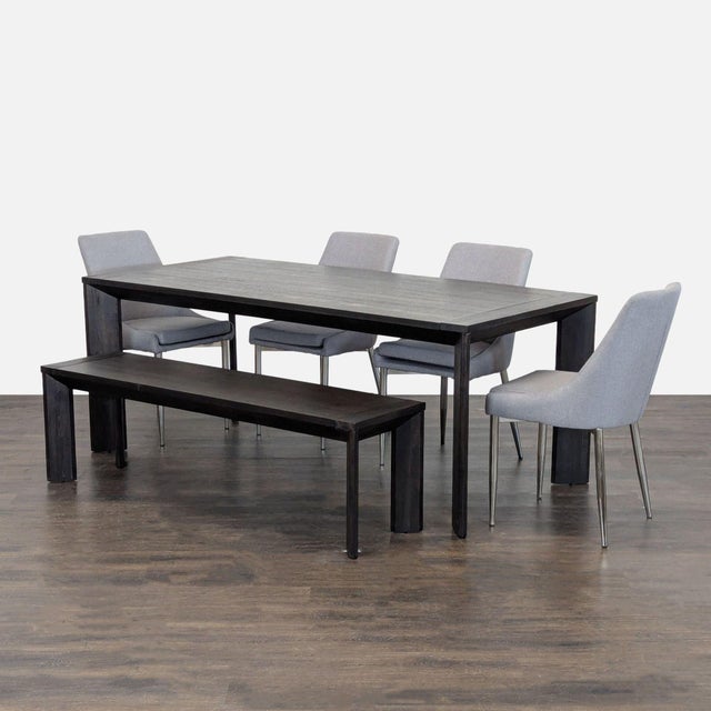 This Living Spaces dining set includes a sturdy rectangular table, four comfortable grey upholstered chairs, and a...