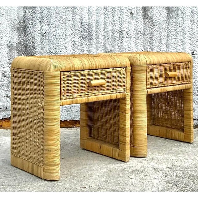Add a touch of natural charm to your space with this stunning pair of vintage coastal woven rattan nightstands. Crafted...