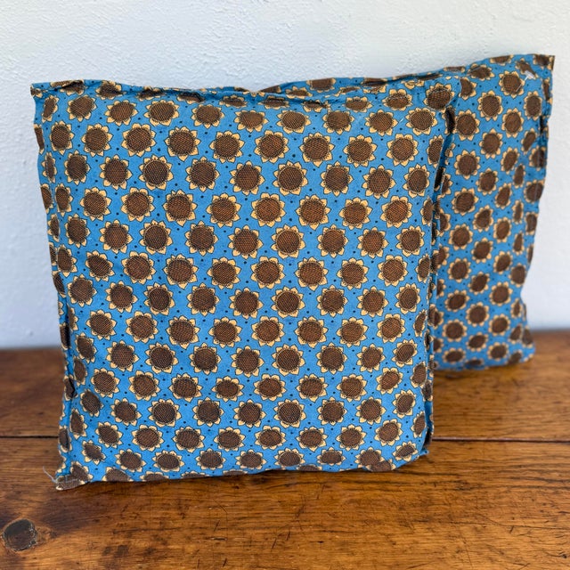 Pair of small handmade square pillows in a blue cotton print with brown and gold sunflowers. Each pillow has a flanged...