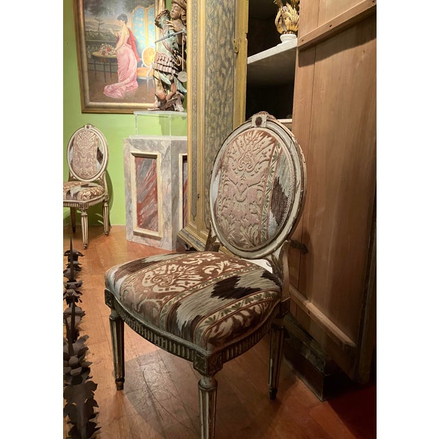 Elegant pair of louis xvi period side chairs in ivory lacquer and gilt wood, featuring refined hand-carved details and...