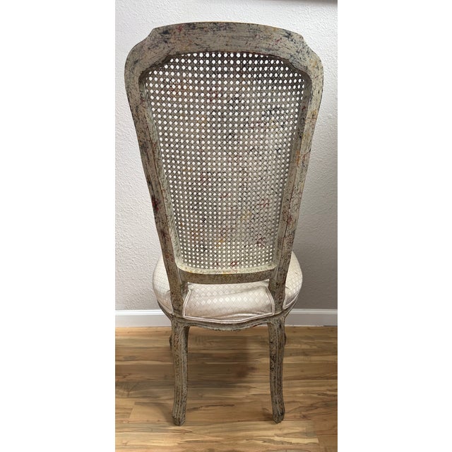 Modern side chair with caned high seat back; gray/red/black/gold/silver metallic distressed wood finish; light gray...