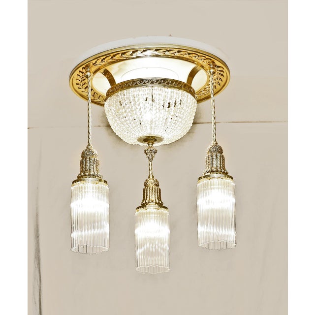 Art Nouveau ceiling lamp, circa 1915. Floral brass ring mounted on a white wooden base. Three twisted brass tubes. Crystal...