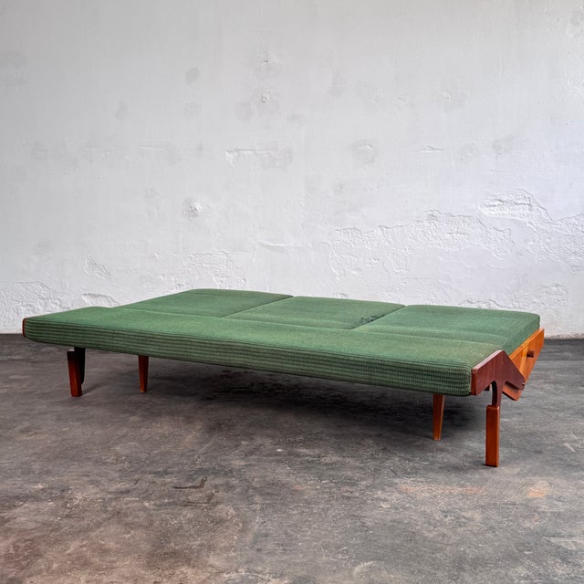 This convertible sofa is a practical example of czechoslovak mid-century design, manufactured by opp drevovyroba during...