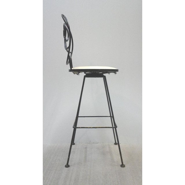 Carolina Woodard heavy duty iron bar height stools with scrolled design and swiveling seats. 18"W x 18" Deep X 45"H with a...