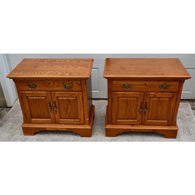 Vintage (1980's) Pair of Nightstands have a Traditional Americana Style. Made by Thomasville. The Wood is Oak. The...