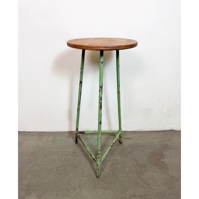 Vintage Industrial factory stool made in former Czechoslovakia during the 1960s It features a plywood seat and a green...
