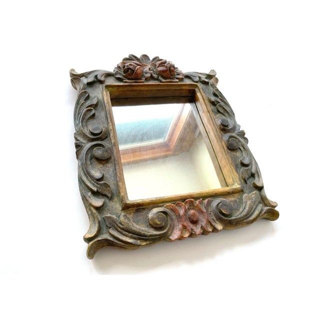 Here is a molded resin mirror with faux carved wood flower accents and embellishments. 15 1/2 by 12 inches - perfect sweet...