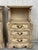 Carved French Rococo style pair of nightstands with open shelve and three drawers, circa 1930s. The tables stands on four...