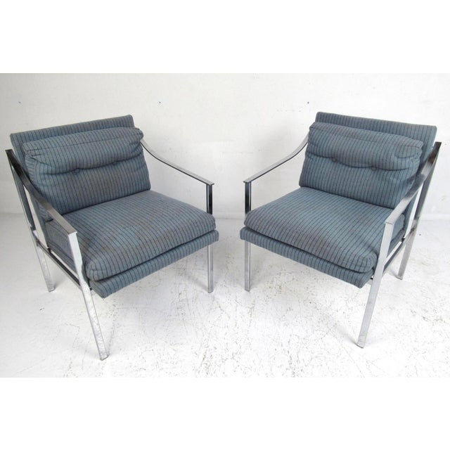 This stunning vintage modern pair of lounge chairs feature a heavy flat bar chrome frame and thick padded seats. The...