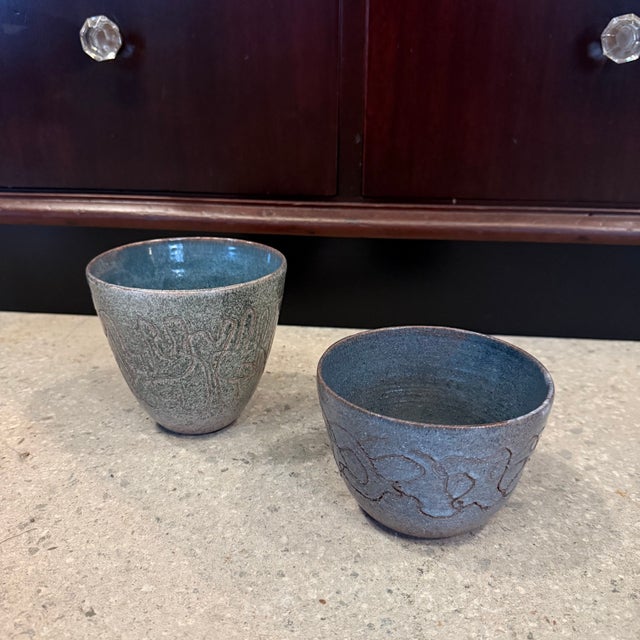 This pair of mid-century modern art pottery bowls showcases a distinctive primitive modernist aesthetic. Hand-thrown with...