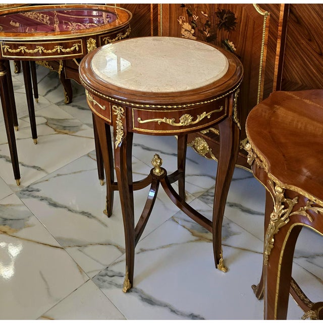 An exquisite French Louis XV style accent table showcasing a beautifully crafted marquetry top, elegant cabriole legs, and...