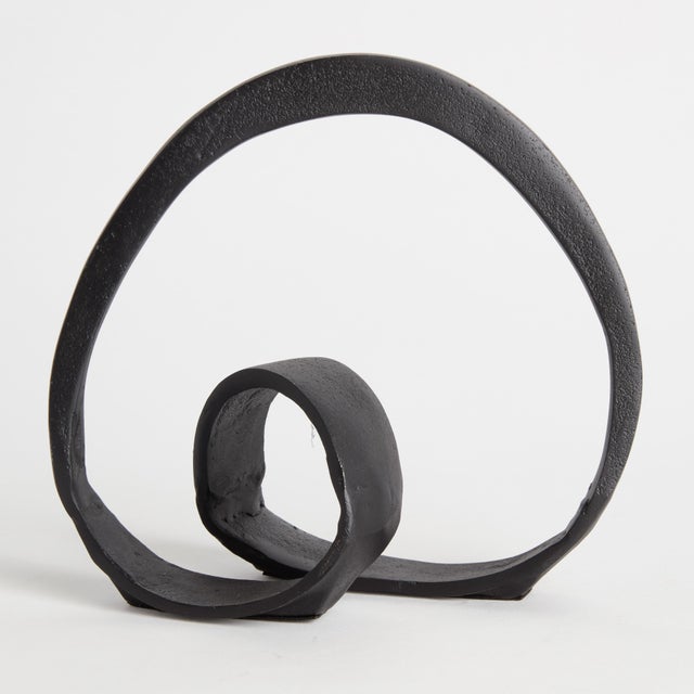 Simple in form and decidedly abstract, this sculpture is inherently organic in feel. With a black matte finish, a handsome...