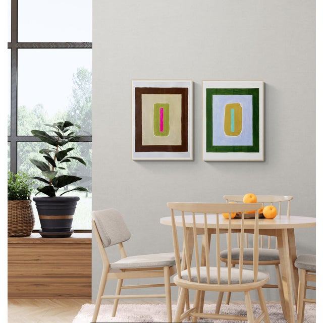 This contemporary design features blocks of layered shapes with a hot pink center rectangle floating on an olive green...