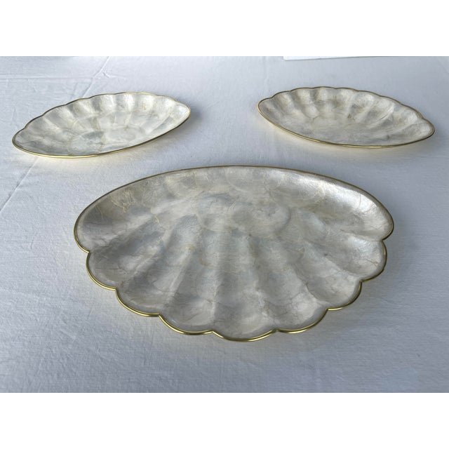 Set of 3 sea shell shape appetizer serving trays with brass rims and cork bottoms. In very fine condition. Hand made in...