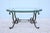 Gorgeous 1980s French wrought iron oval coffee table with beveled glass top. Features a hand forged iron base with classic...
