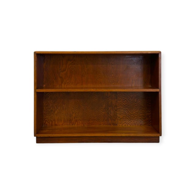 This vintage mid-century low-profile bookcase features an open, two-tier horizontal storage layout crafted with...