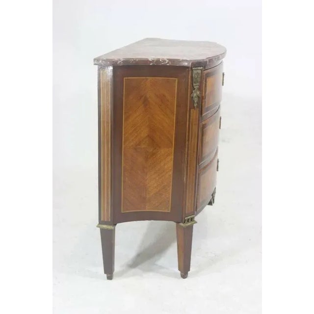 A refined French Louis XV style in perfect scale, three-drawer serpentine front chest with parquetry inlay kingwood and...